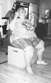 photo of large woman lifting hand weights